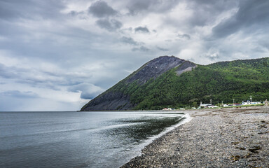 Wall Mural - View on a cloudy on the cliffs, the beach, the St Lawrence river in Mont Saint Pierre, a small village on the northern shore of the Gaspesie peninsula in Quebec (Canada)