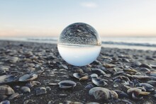 Close-up Of Crystal Ball On Beach