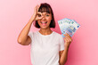 © Asier - Young mixed race woman holding bills isolated on pink background excited keeping ok gesture on eye.