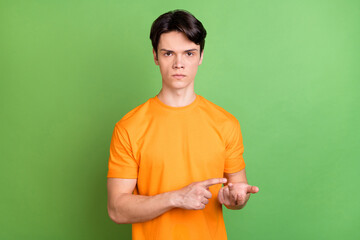 Sticker - Photo of young unhappy angry man count fingers bad mood dislike negative isolated on green color background