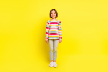 Wall Mural - Full body photo of charming happy attractive girl good mood smile cute isolated on shine yellow color background