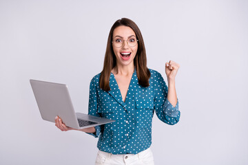 Poster - Portrait of attractive trendy cheerful girl holding using laptop having fun isolated over gray pastel color background