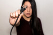 © AliciaFdez - A brunette young girl holding an electrical plug. European type c plug on focus