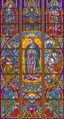 Wall Mural - VIENNA, AUSTIRA - JUNI 24, 2021: The  Immaculate Conception of Virgin Mary from Guadalupe on the stained glass in the Votivkirche church originaly by by Hans Schweiger (1963).