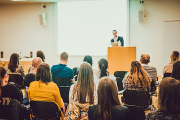 audience in lecture hall on scientific conference.