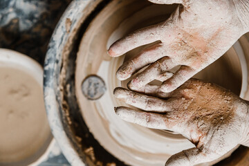 Female ceramist hands sculpt clay dishes