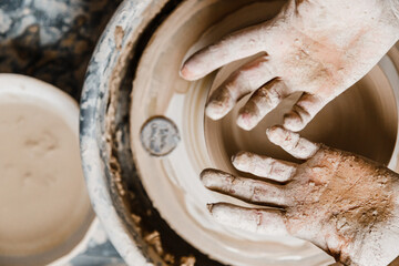 Female ceramist hands sculpt clay dishes