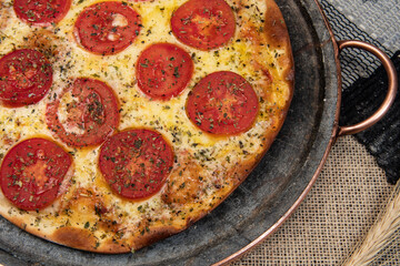 Neapolitan Brazilian pizza with mozzarella cheese and tomato slices with oregano