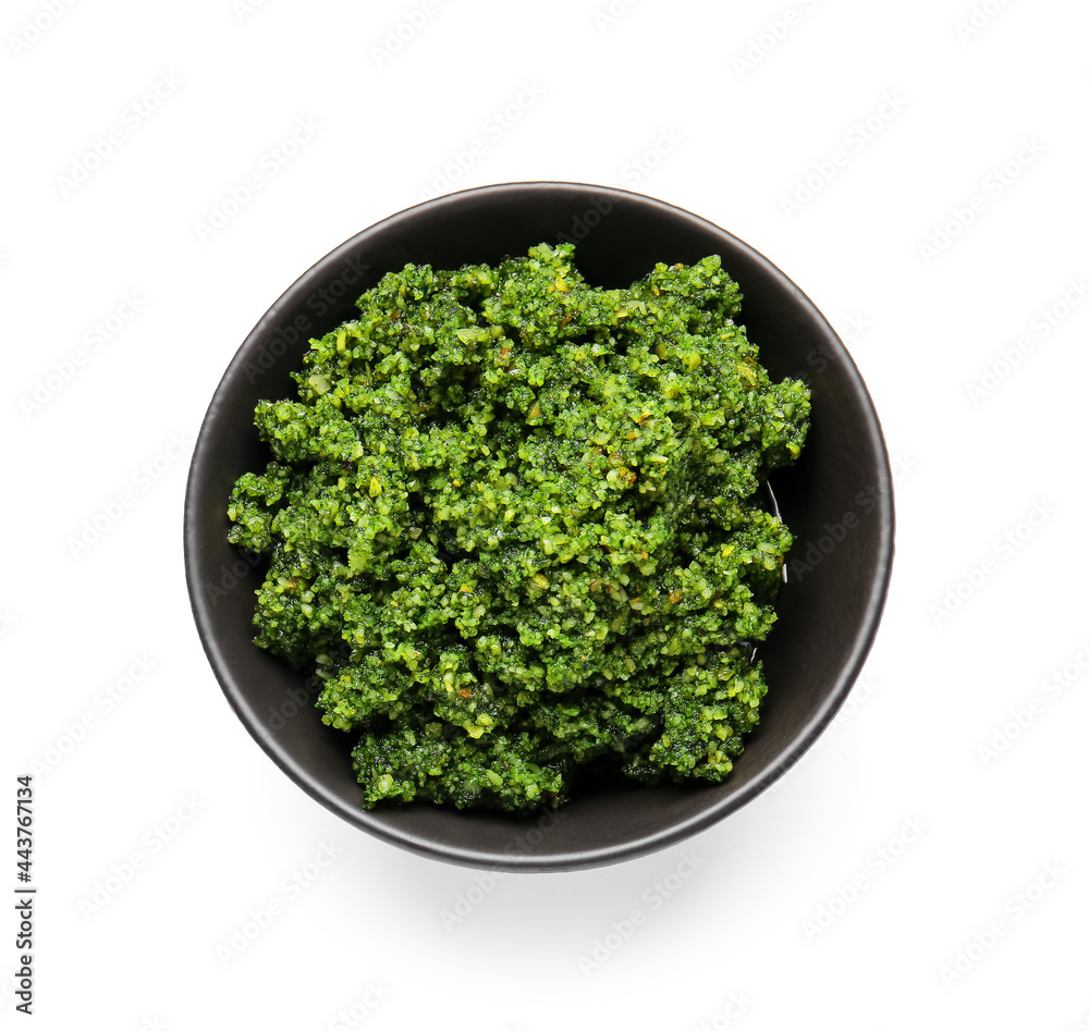 Bowl with fresh pesto sauce on white background