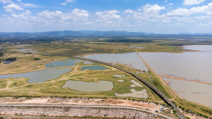 Aerial Unseen view of railroad tracks of floating Train bridge with white car in Khok Salung, Pa Sak Jolasid dam Lopburi amazing Thailand, Known as a floating train route.