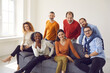 © Studio Romantic - Diverse people group of different age and ethnicity sitting on sofa couch in office posing and looking at camera. Casual colleagues friendly smiling. Team, friendship and relationship. Human community