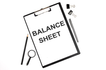 Poster - On a white background magnifier, a pen and a sheet of paper with the text BALANCE SHEET . Business concept