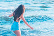 © ARVD73 - Young woman playing in the sea.woman enjoying in sea water .Cheerful young woman having fun on the summer beach.