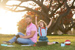© Volodymyr - Outdoor learning. Father with son in park, preparing homework, parenting.