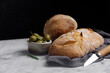 Rustic sourdough ciabatta bread with olives on a marble table. Freshly baked artisan ciabatta bread