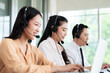 © SEVENNINE_79 - Team of call center staff in Asia wears headphones with a microphone. Smile while serving customers at desks and computers. Service concept and consulting. Communication concept.