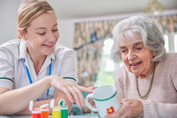 Wall Mural - Senior Woman Painting Cup With Art Therapist