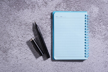 Poster - blue blank note pad on cement background