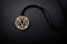 Yakut Female Amulet Made Of Wood On A Black Background. Wooden Traditional Talisman. Boho Style