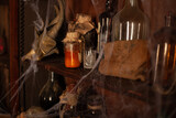 Fototapeta Na sufit - Halloween background Shelves with alchemy tools Skull spiderweb bottle with poison candles
