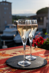 Romantic wedding party with two glasses of white cold champagne and view on yachts and houses of Port Grimaud, French riviera, France