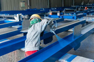 Wall Mural - Painter is painting a steel H-beam of steel structure work with spray gun.