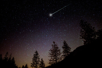 starry night sky and shooting star