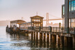 Incredible view of the pier and embankment in San Francisco at sunrise, the Oakland Bay Bridge is visible in the background