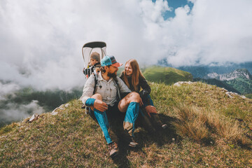 family having fun in mountains hiking together with baby travel adventure vacations outdoor healthy 