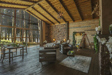 Dark Cozy Interior Of Big Country Wooden House, Wooden Furniture And Animal Furs. Huge Panoramic Window And Very High Ceiling.
