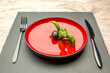 Diet. Small amount of food on the plate. One olive is in a red plate, a knife and a fork. Weight loss and diet concept. Empty space for text