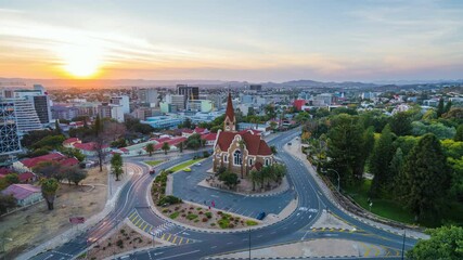 Wall Mural - Day to night timelapse view of traffic around historic landmark Christ Church aka Christuskirche in Windhoek, the capital and largest city of Namibia.	