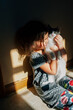 © Jessica Klaus/Stocksy - Shadowy portrait in the kitchen.
