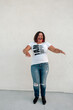 © Erin Brant/Stocksy - Laughing Black woman in jeans and t-shirt