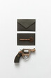 © Yaroslav Danylchenko/Stocksy - Black envelopes, gun and key
