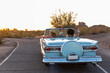 © Raymond Forbes Photography/Stocksy - Two Best Girlfriends Girls on Desert Road trip driving down road in classic car