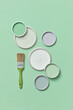 © Yaroslav Danylchenko/Stocksy - Different lids of paints on green background