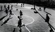 © Jimena Roquero/Stocksy - Group of people playing football in an outdoor court
