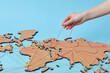 © Yaroslav Danylchenko/Stocksy - Woman holding thread above map with connections