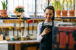 © Inuk Studio/Stocksy - Cheerful craftswoman with smartphone in woodwork workshop