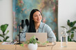 © Studio Marmellata/Stocksy - Cheerful radio host looking away in open space studio