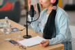 © Studio Marmellata/Stocksy - Crop woman recording podcast and gesticulating in studio