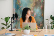 © Studio Marmellata/Stocksy - Thoughtful woman looking away before recording podcast