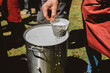 © Anna Malgina/Stocksy - Man's hands making fresh ricotta cheese