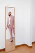 © Eloisa Ramos/Stocksy - Elegant man reflected at mirror
