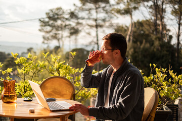 Freelancer man remote Working On A Laptop Outdoors