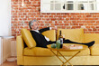 © Ivan Gener/Stocksy - Mature businessman drinking wine after work