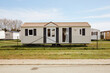 © Javier  Márquez/Stocksy - Modern mobile home behind fence