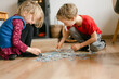 © Léa Jones/Stocksy - boy and girl solving a jigsaw puzzle