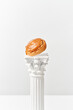 © Yaroslav Danylchenko/Stocksy - Tasty cookie on white column